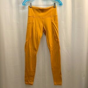 ATHLETA bright orange leggings with side pockets size XS